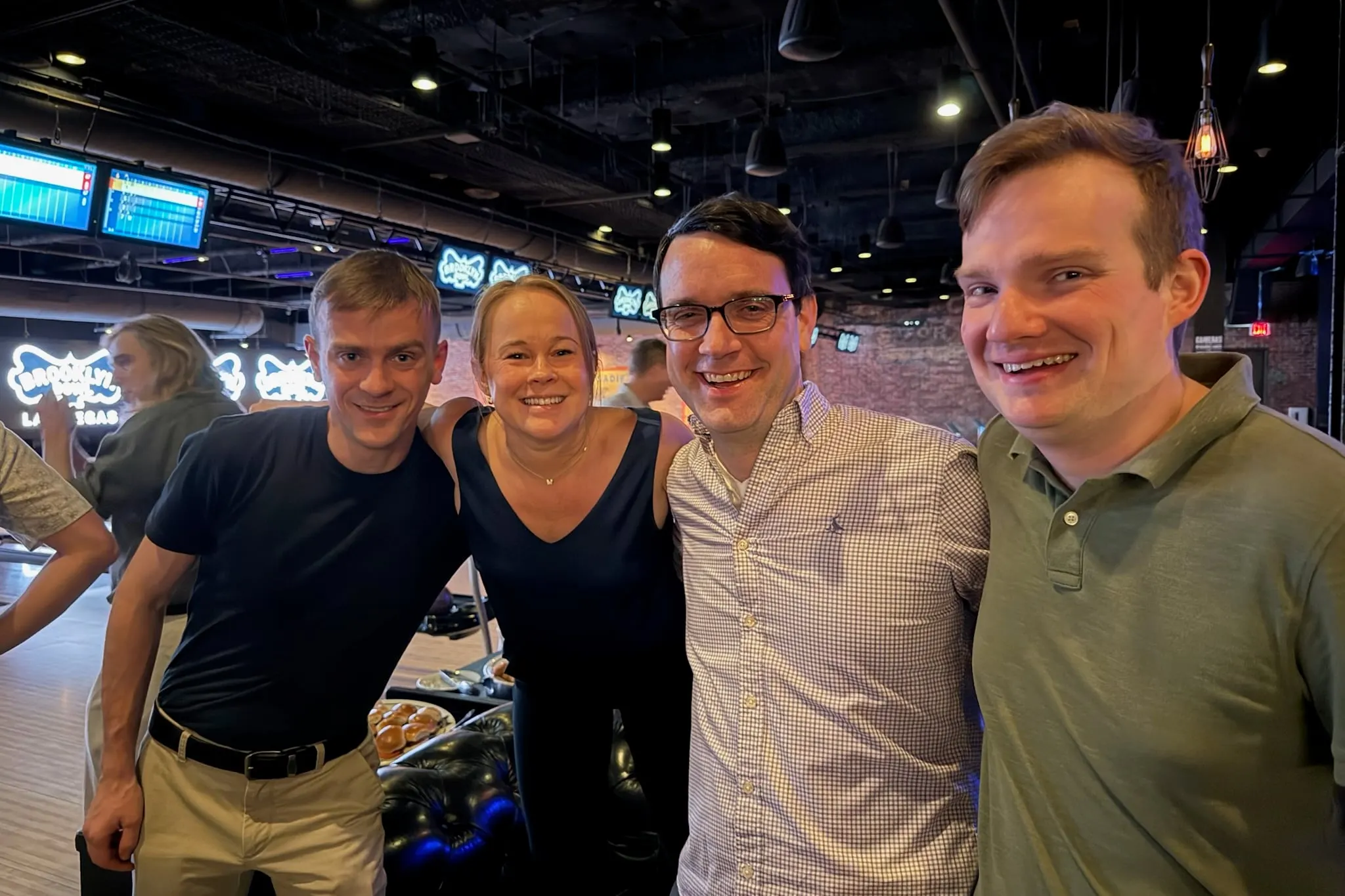 Four Semaphore Partners team members at the client appreciation event at Brooklyn Bowl during Knowledge 2026 in Las Vegas